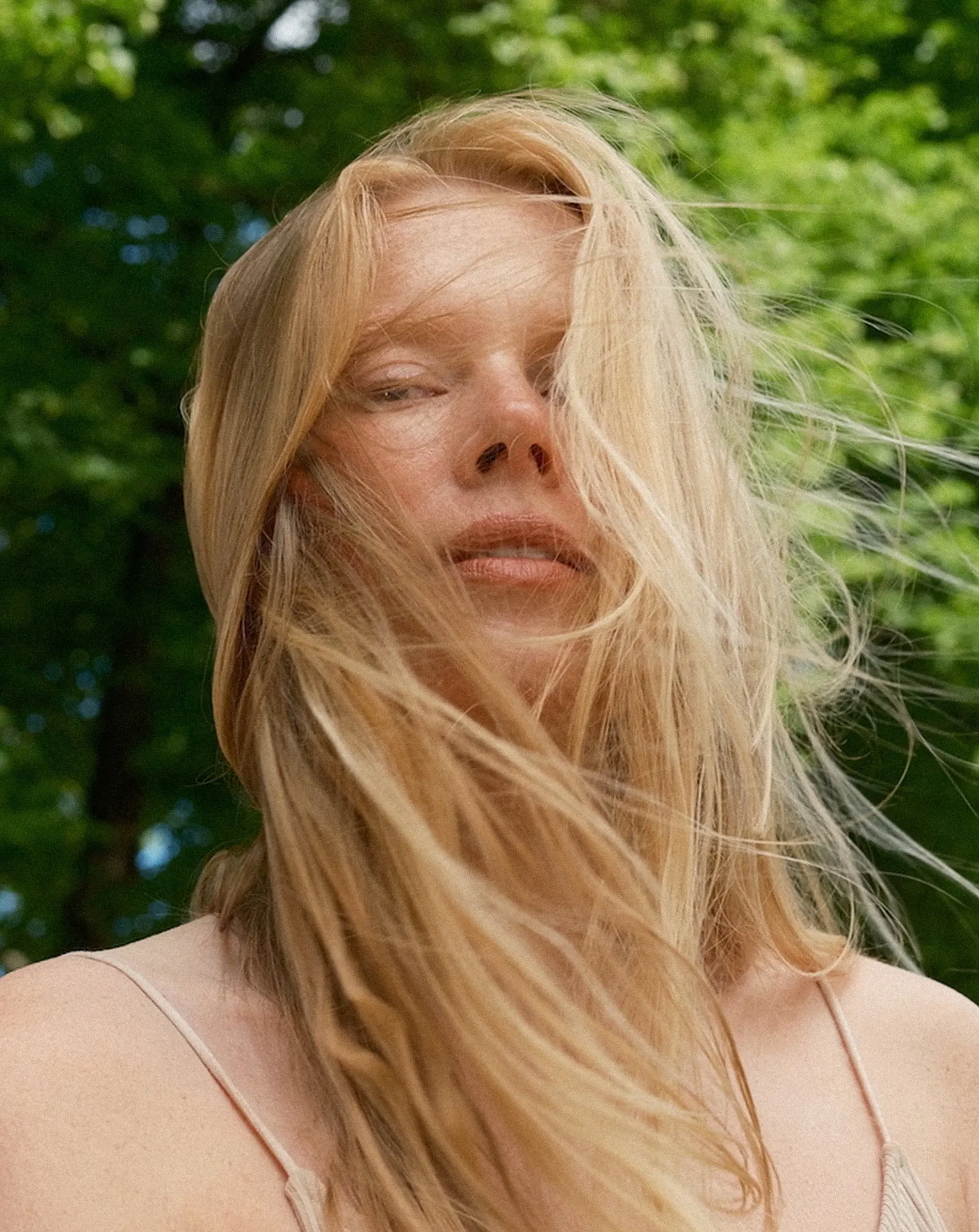 Woman with windswept blonde hair outdoors
